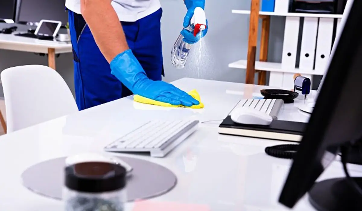 a professional cleaner wiping the table surface