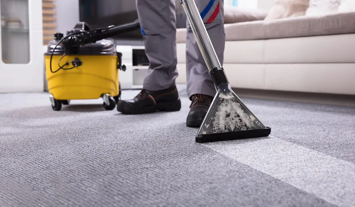 a man cleaning using vacuum cleaner