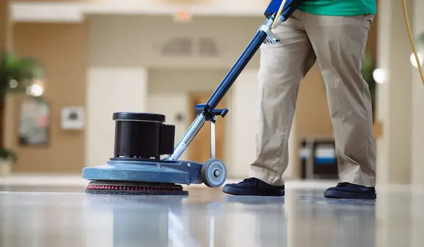 man vacuums floor in a building