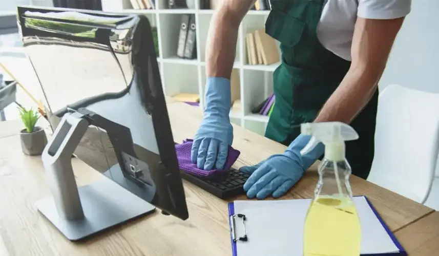 woman cleaning office desk